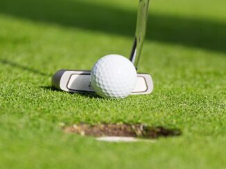 golf club hitting golf ball on golf course
