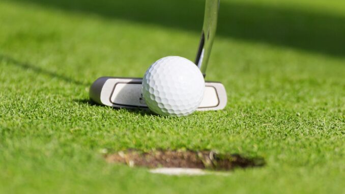 golf club hitting golf ball on golf course golf club hitting golf ball on golf course